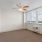 a room with a window and ceiling fan